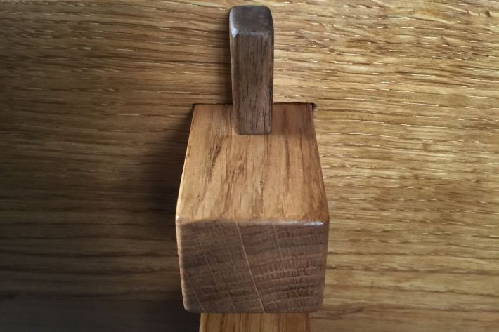 Walnut pegs hold frame secure