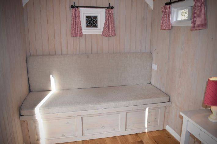 Shepherds hut interior showing colour-wash bead and butt and pull-out day-bed