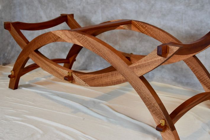 Experimental table frame in mahogany curved forms